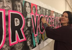 Professor Sandra Kelch works banner in preparation for the San Francisco Women's March 2018.