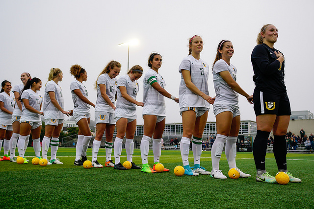 USF Women's Soccer holds hands at the start of their game.