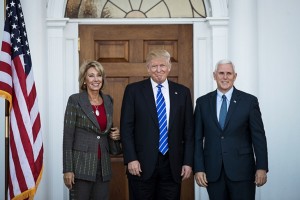 Betsy DeVos with Donald Trump and Mike Pence