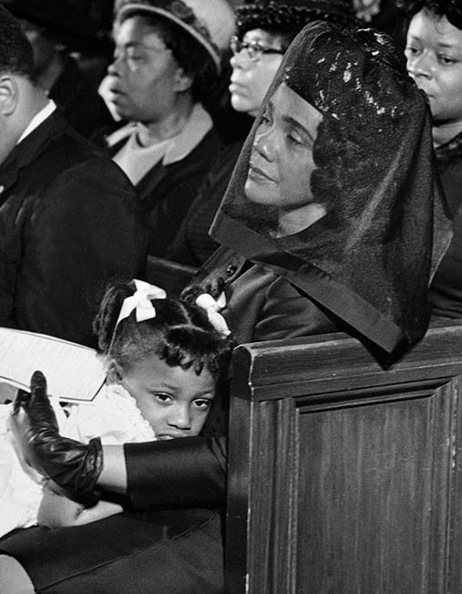 Coretta Scott King at the funeral of Martin Luther King, comforting their 5-year-old daughter, Bernice.