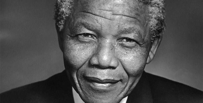 Nelson Mandela softly smiles in black and white