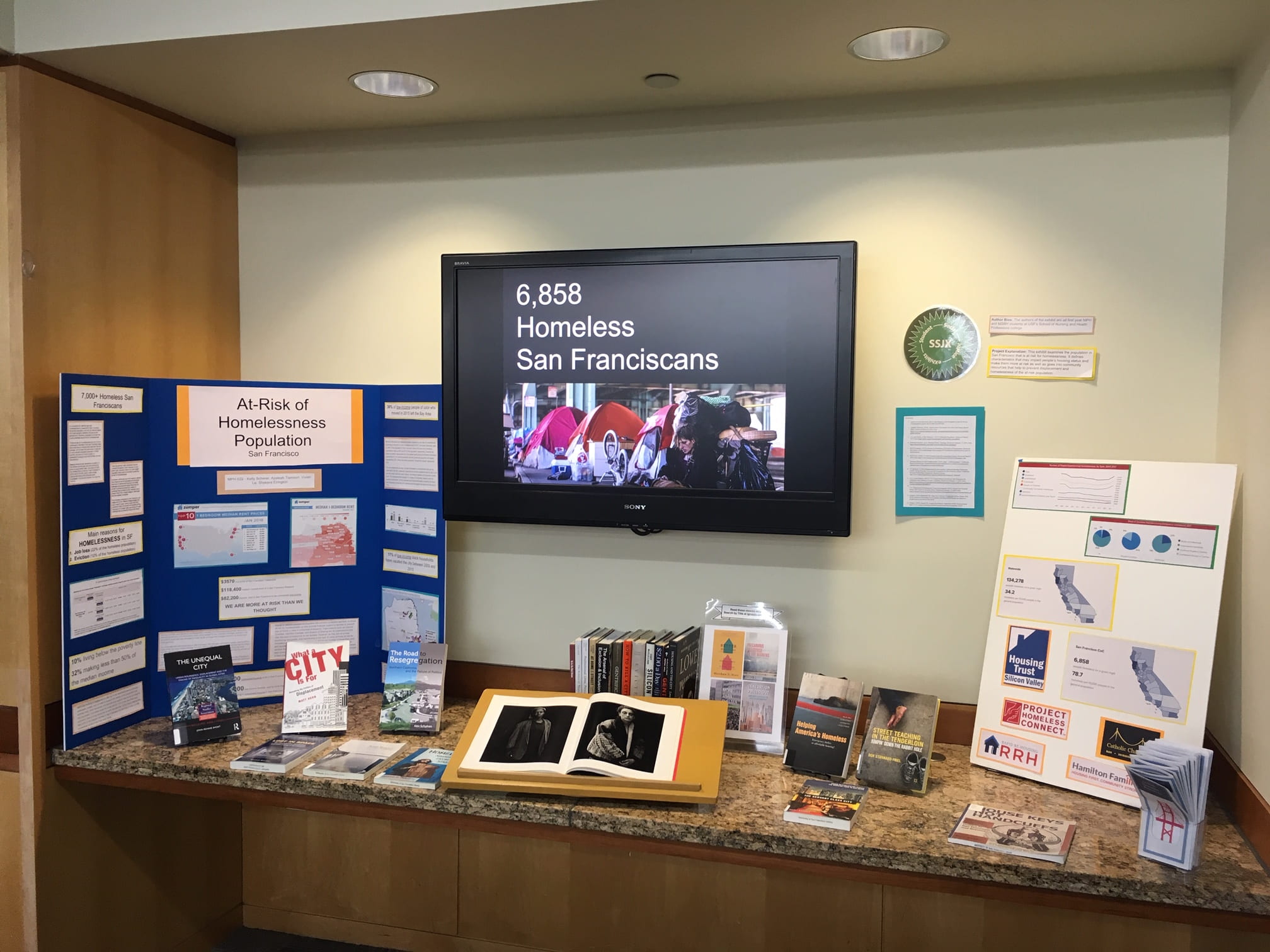 display of student projects on At-Risk Homelessness Population with books and handouts for more information