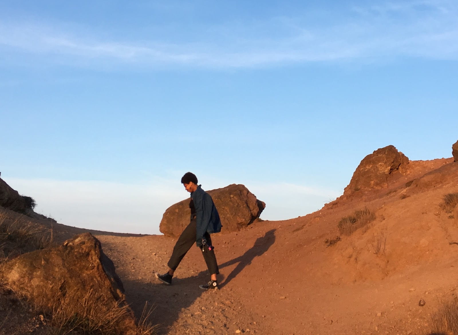 Photo of Zoe walking on desert terrain