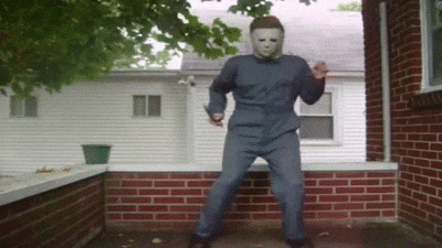 Gif of a person dressed up as Michael Myers from the movie Halloween. Person is dancing to inaudible music.