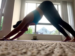 Woman in downward facing dog yoga position
