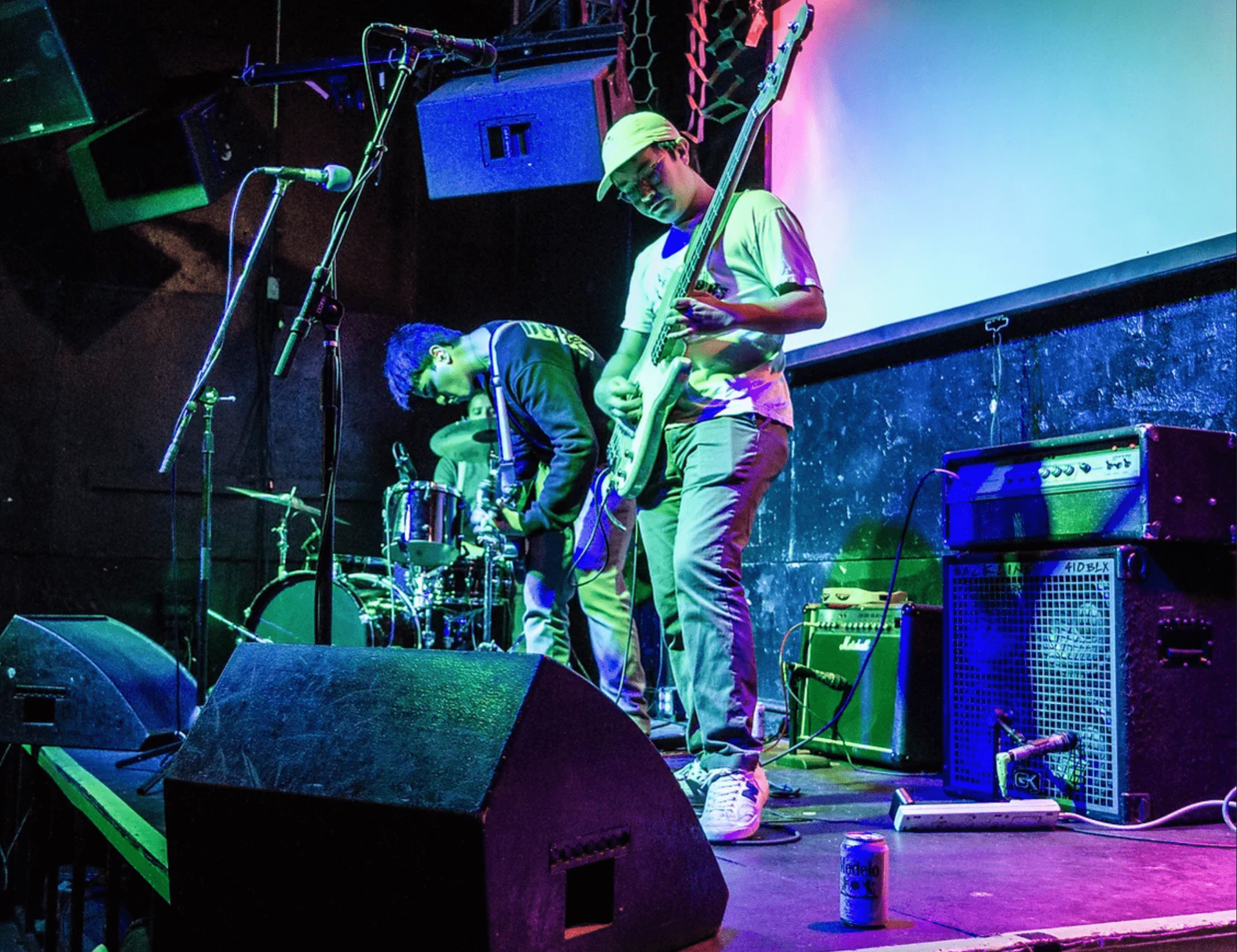 two musicians on a stage in blue light
