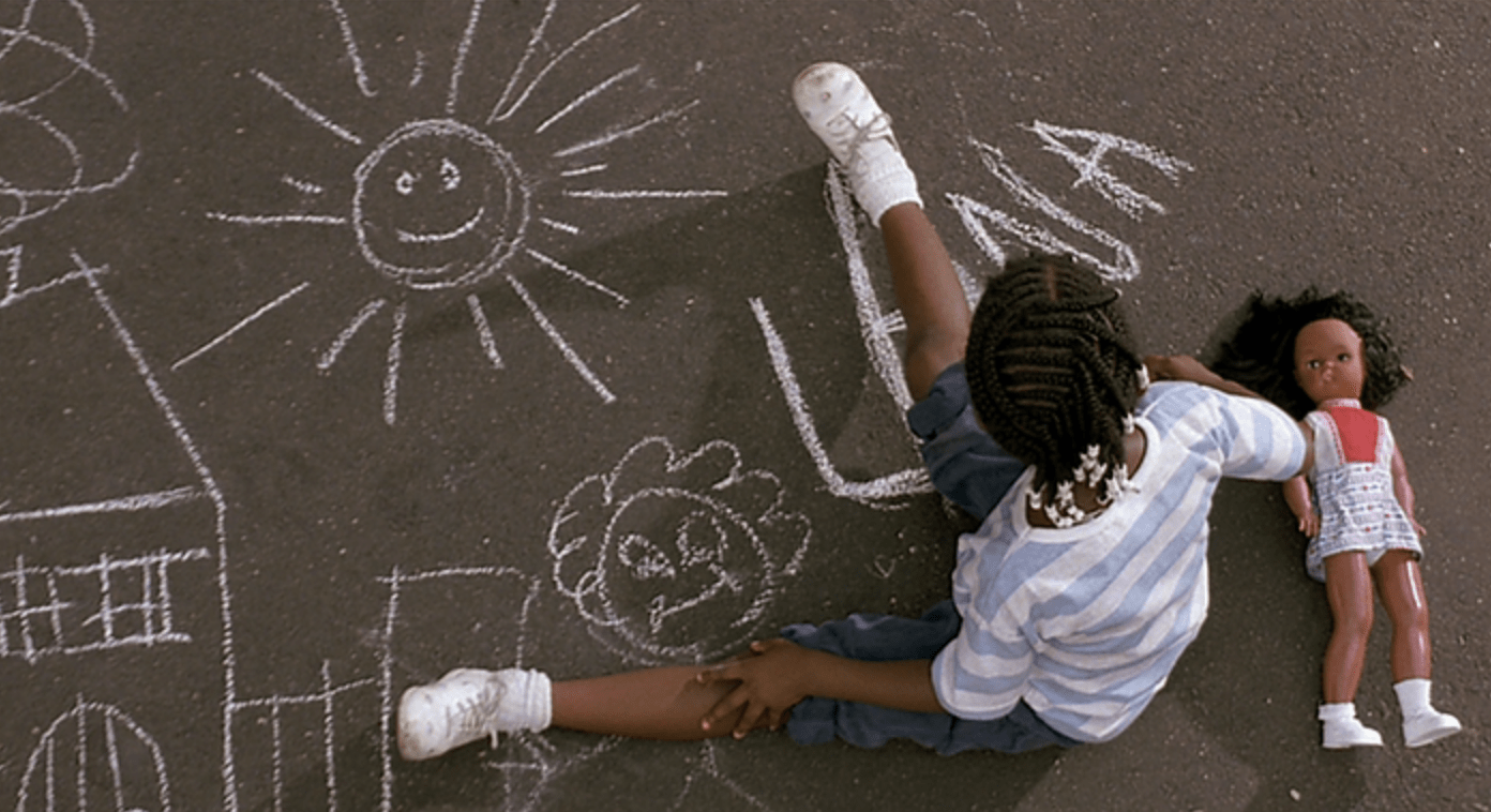 overhead view of a young girl drawing pictures on the pavement