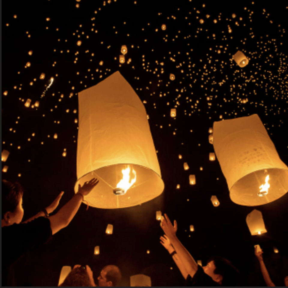 paper lanterns against a black night sky