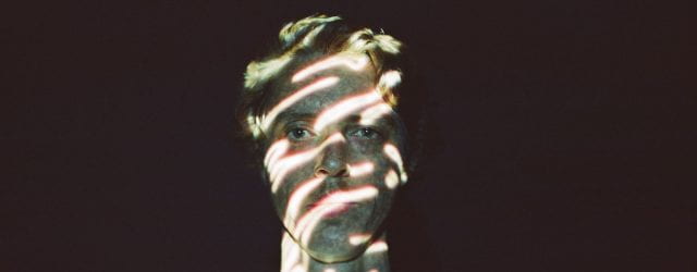 young man with projections across his face