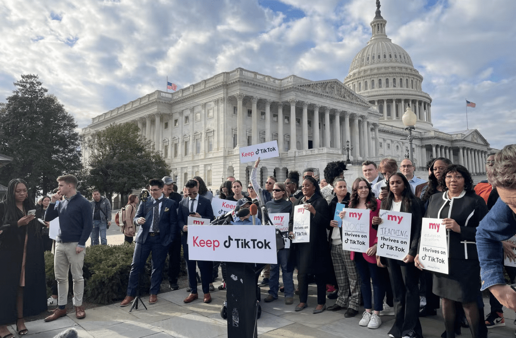 protesters holding signs in support of TikTok outside of the US Capitol building