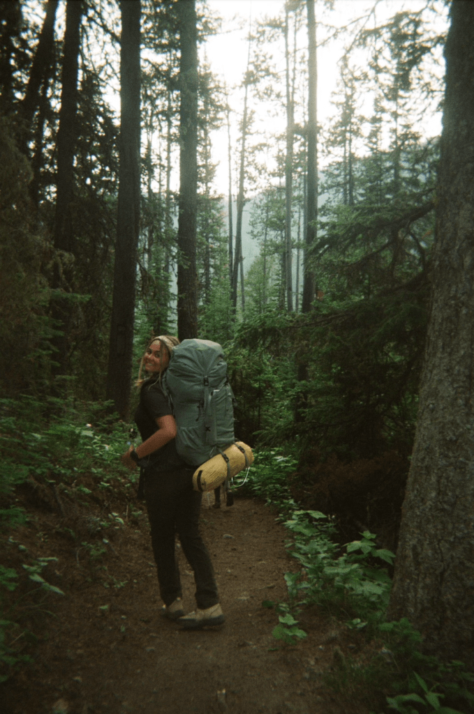 Photo of Skyler Seamons on a forest hike