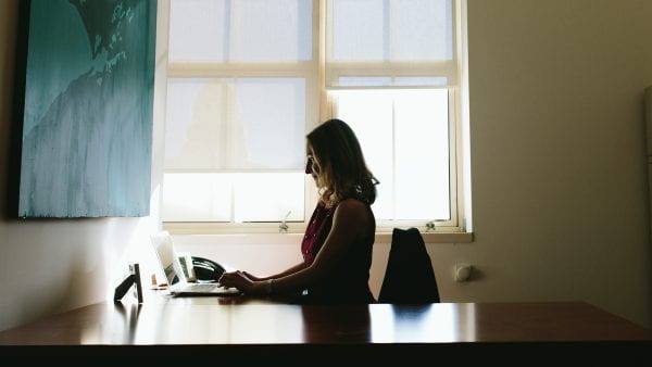 Erin Brigham sitting at desk using laptop