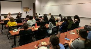 MFT students in classroom listening to presentation