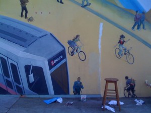 mural section showing San Francisco streetcar and two exuberant cyclists