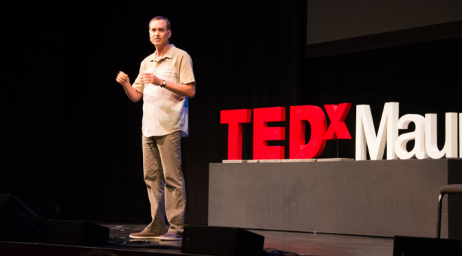 speaker standing in front of TEDx logo