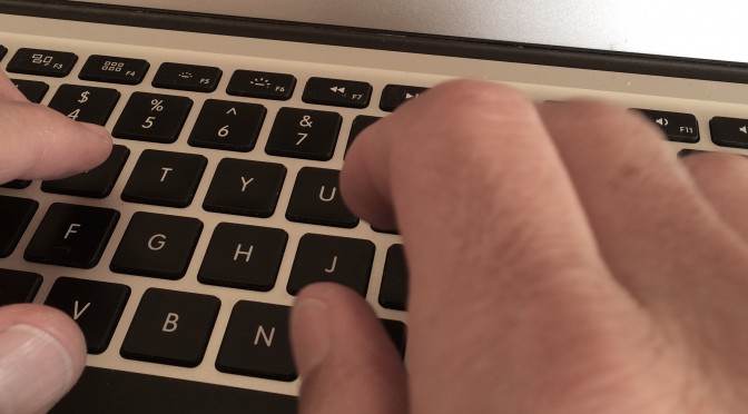 hands at a laptop keyboard