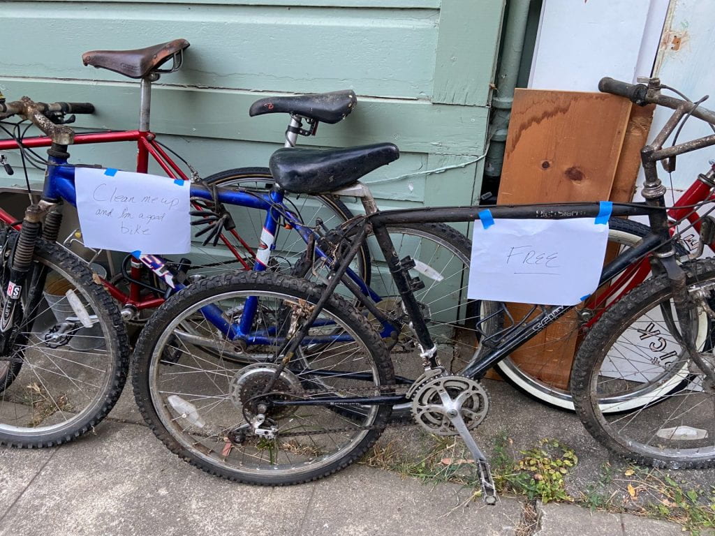 Two filthy crusty old bikes with "free" signs