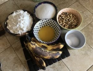 Banana muffin ingredients sorted into bowls.