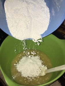 Pouring flour into mixing bowl.