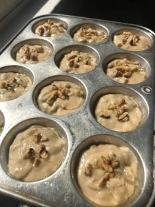 Pre-baked banana muffins in pan.