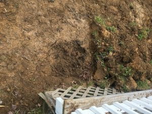 A excavated hole from moving the compost pile.