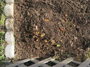 A watered and covered dirt pile.