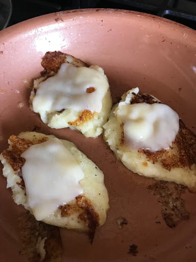 Melted cheese on mashed potato dollops.
