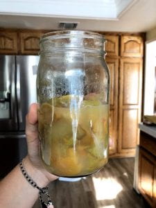 A jar full of apple cider vinegar.