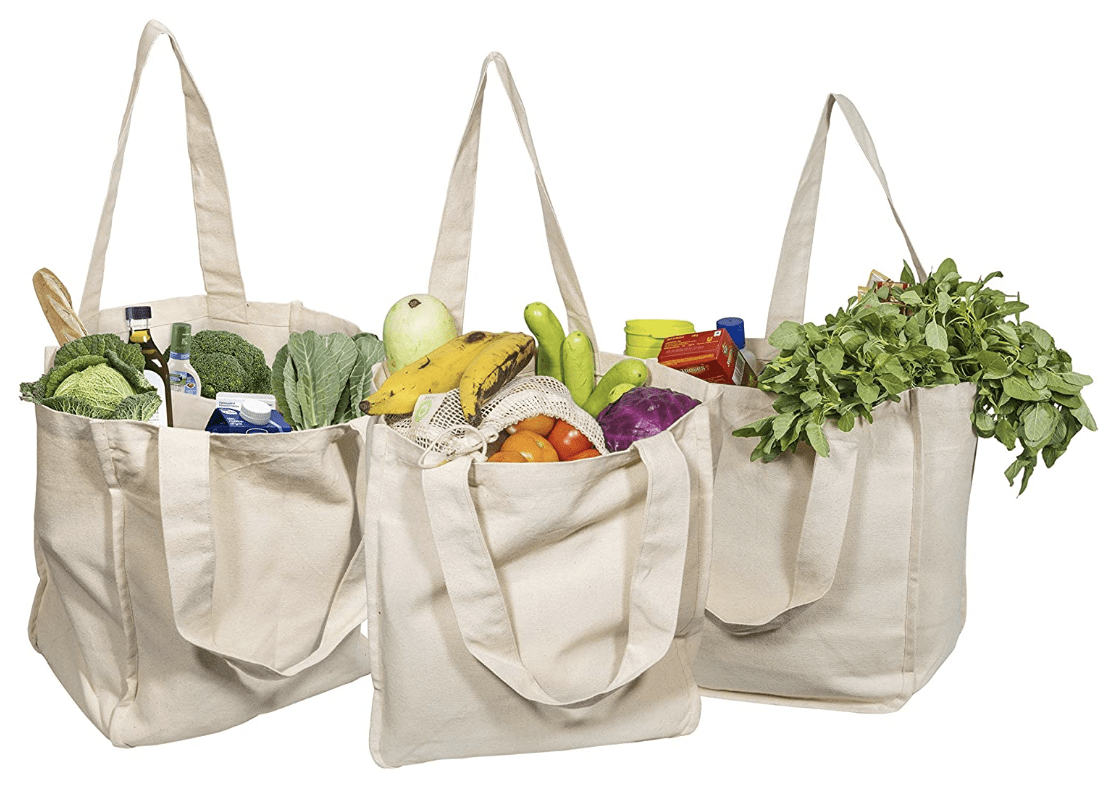 Reusable tote bags containing groceries.