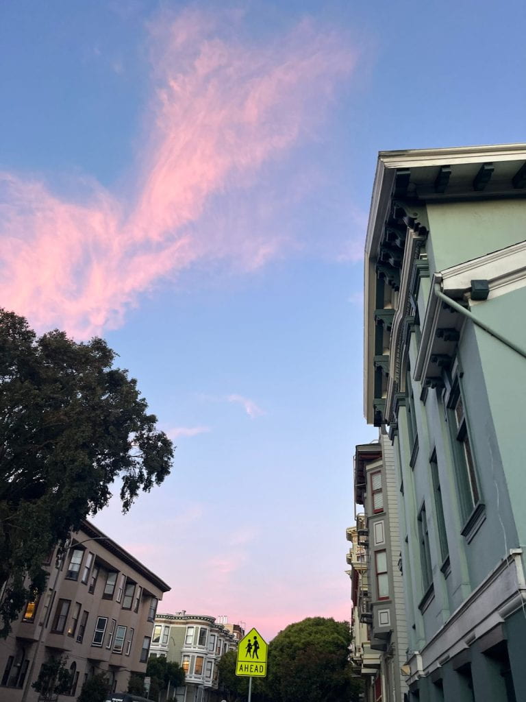 Sky with pink clouds above buildings.