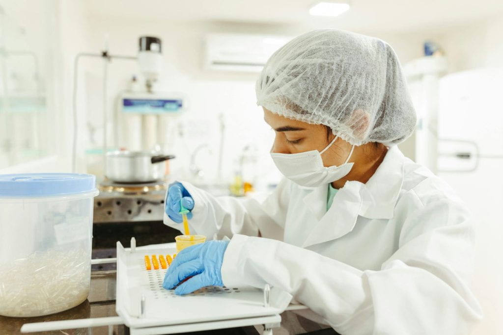Person in a lab testing samples.