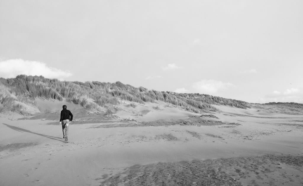 Person standing on a sand dune.